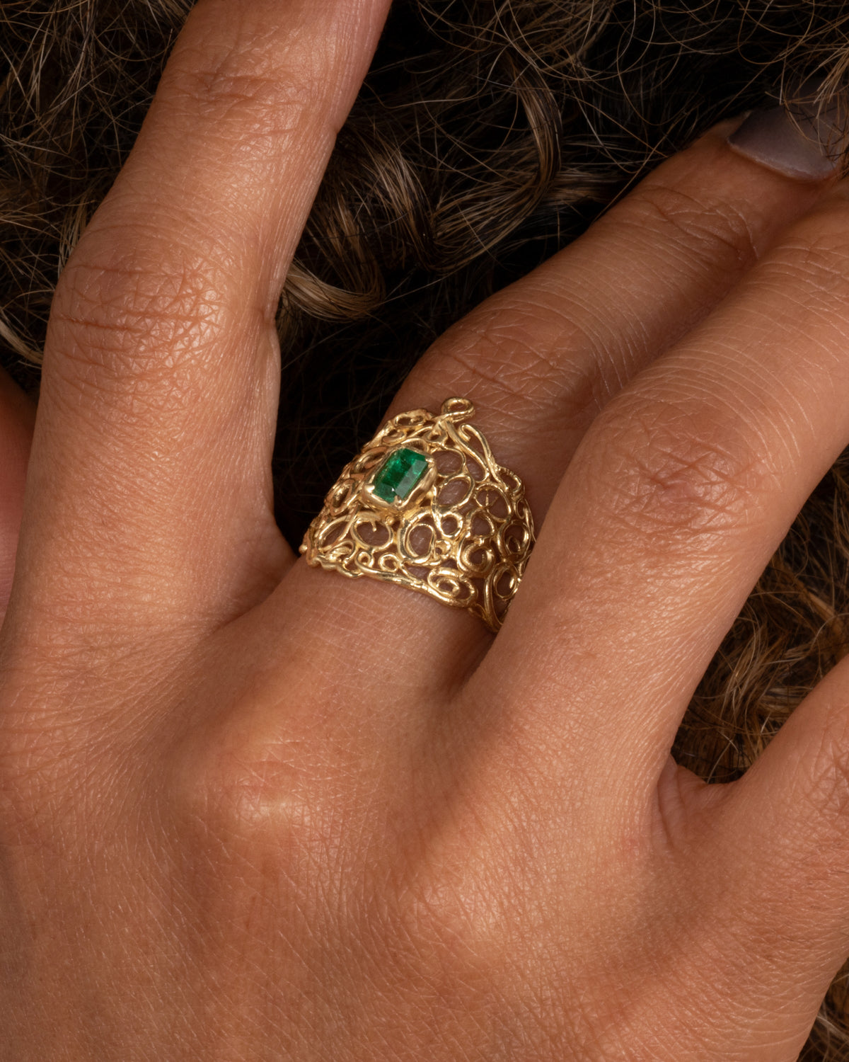 Utopia Ring — worn alone on a hand in close-up.
