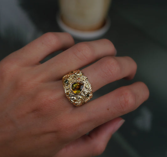The Turning Art Ring — worn alone on a hand in close-up.