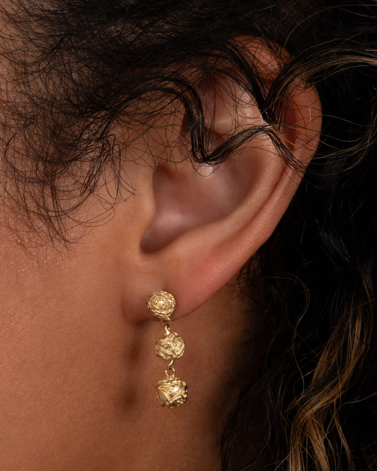 Revelation 3 Drop Earrings — one three-part drop earring worn on an ear.