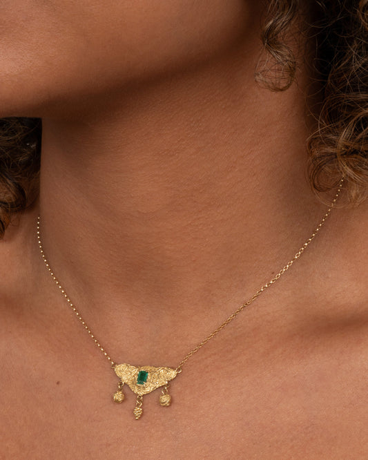 Utopia Necklace — fine chain worn at the neckline.