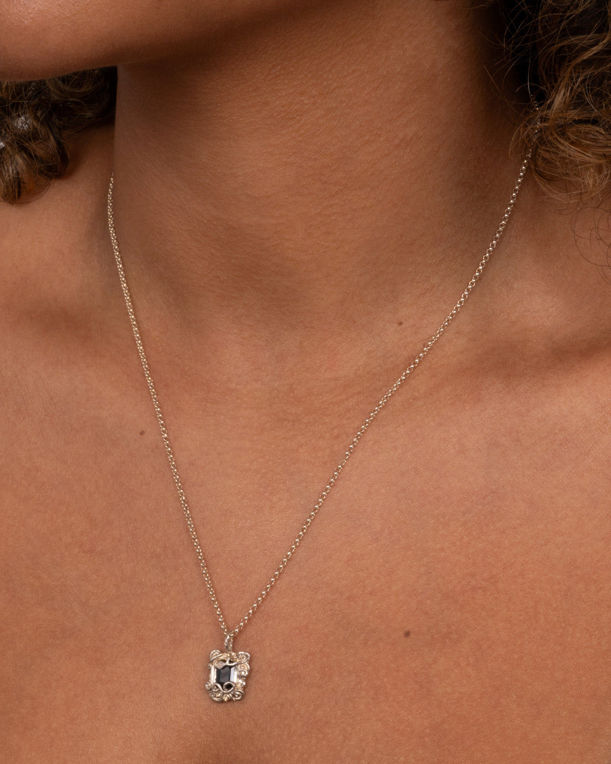 Sapphire Amulet Necklace Silver — fine silver chain worn at the neckline.