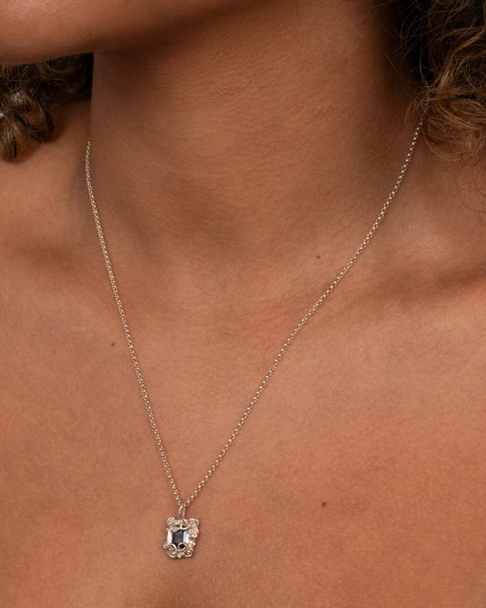 Sapphire Amulet Necklace Silver — fine silver chain worn at the neckline.