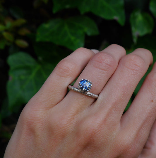 Aurora Ring — worn alone on a hand outdoors.