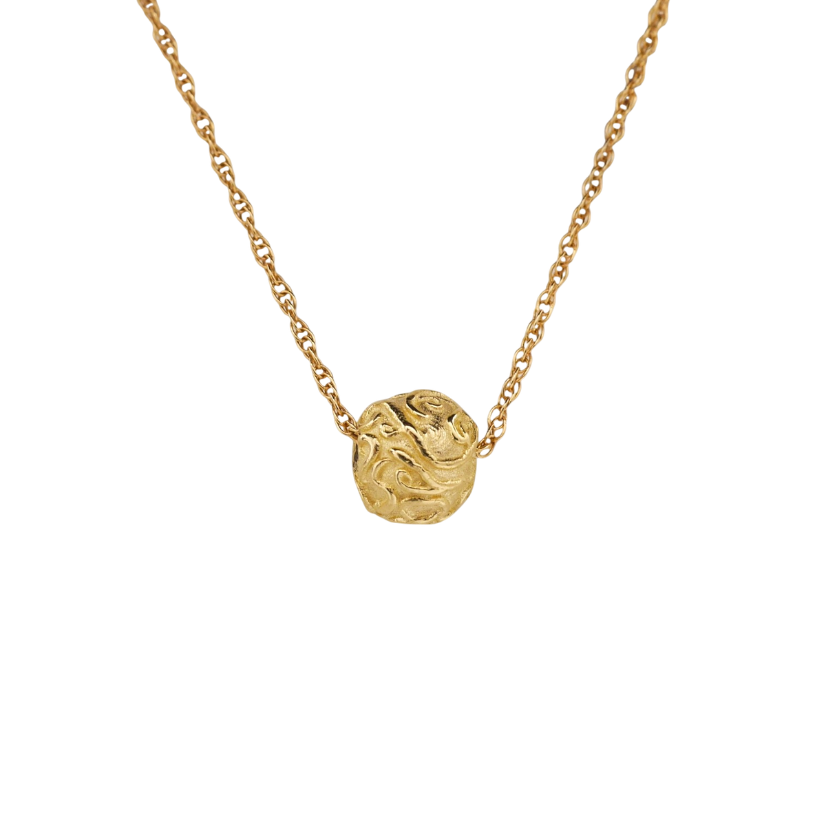 Circular Thoughts — An irregular yellow-gold pendant with raised scrolling relief is integrated into an open organic-link chain.