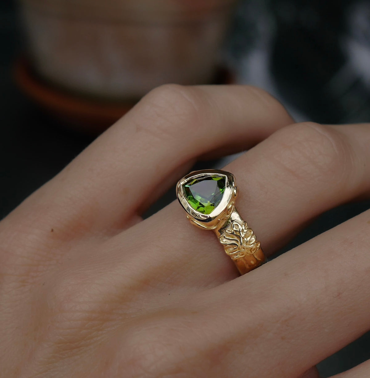 Custom green tourmaline ring worn on the hand
