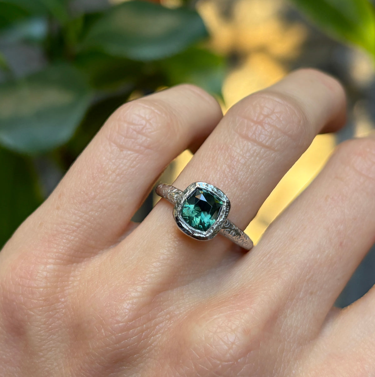Custom sapphire ring worn on the hand