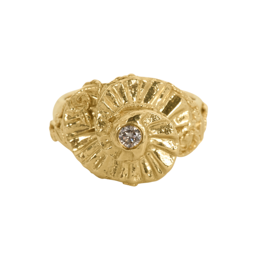 Diamond Ascent Ring — A yellow-gold-colored statement ring holds one round diamond within a high-relief, petal-like sculptural form.