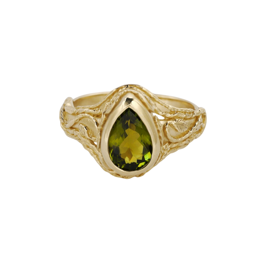 Entangled Ring — An olive-green pear tourmaline is bezel-set within an open yellow-gold ring of intertwined leaves and vines.