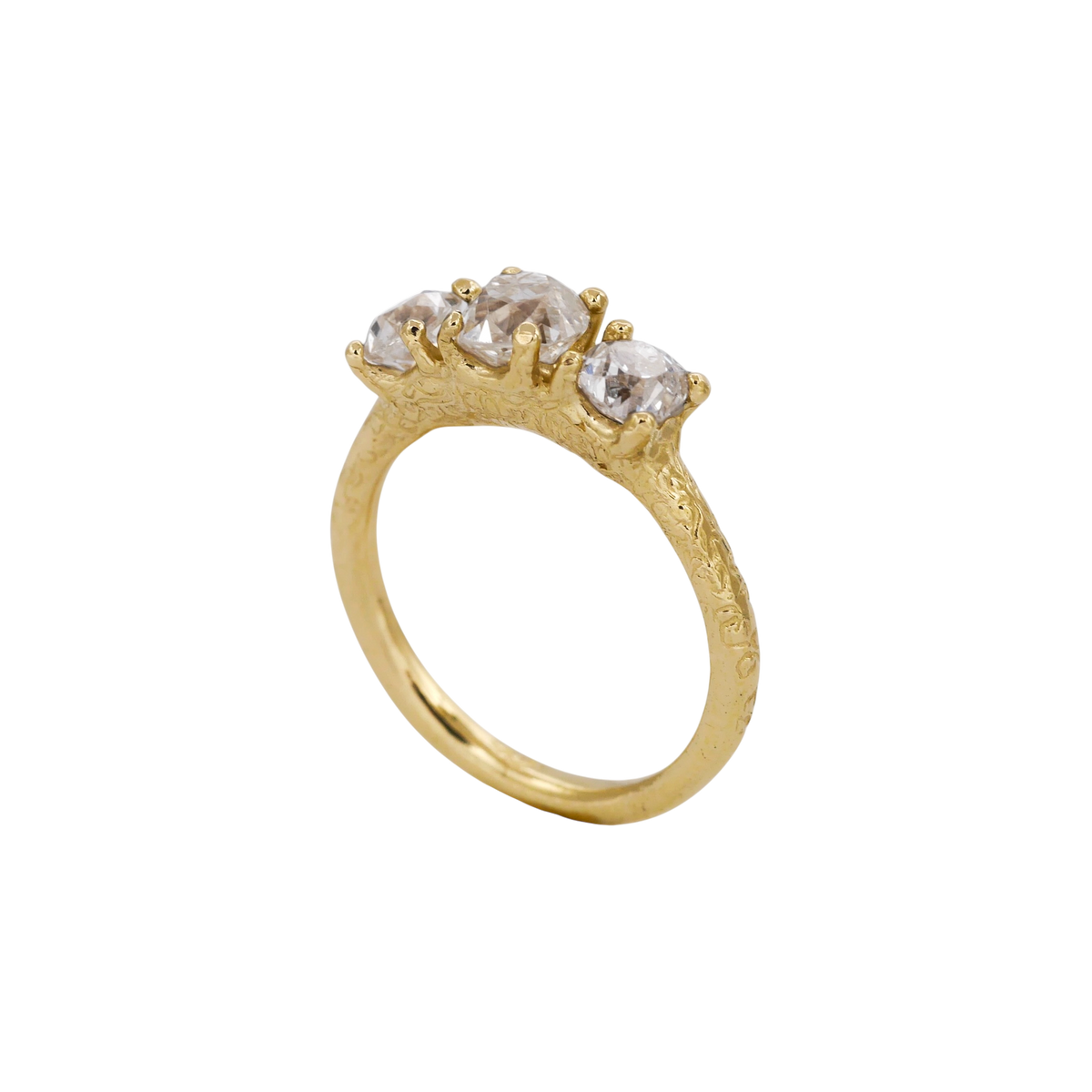 Gathering Ring — three-quarter profile showing the raised three-stone setting.