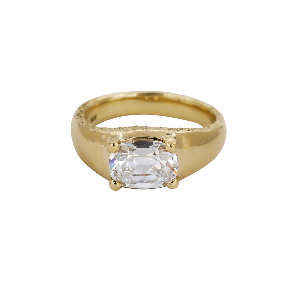 Heirloom Ring — A colorless elongated cushion diamond is held by four rounded prongs above a broad, tapered yellow-gold ring.