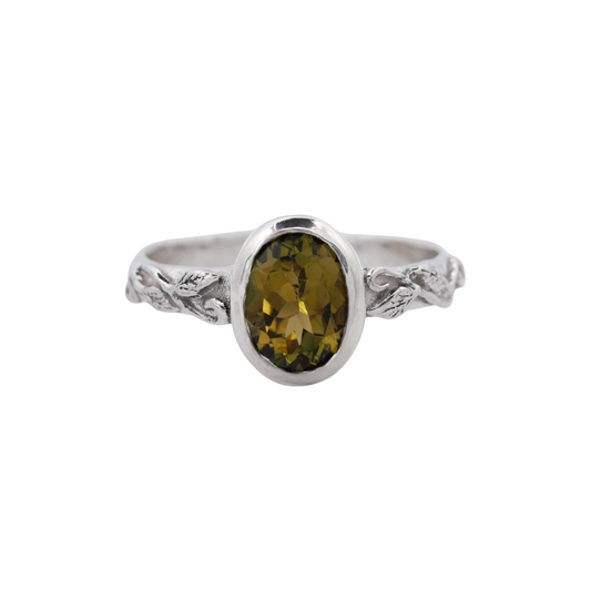 Interlaced Green Tourmaline Ring — An olive-green elongated cushion tourmaline is bezel-set above a sterling-silver band with interlaced botanical relief.