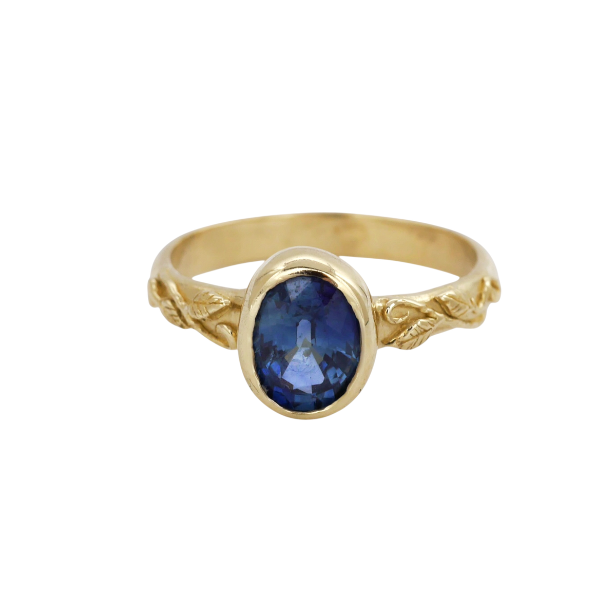 Interlaced Ring Sapphire — three-quarter view of the sapphire bezel and scrolling shoulders.