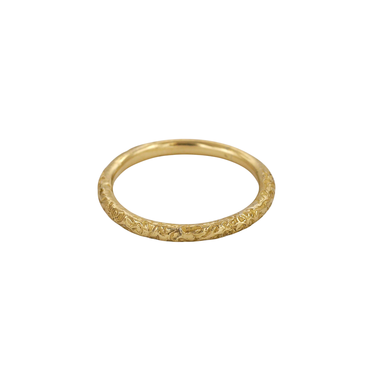 Little Scrolling Band — A slim yellow-gold band carries shallow scrolling botanical relief around its rounded exterior.