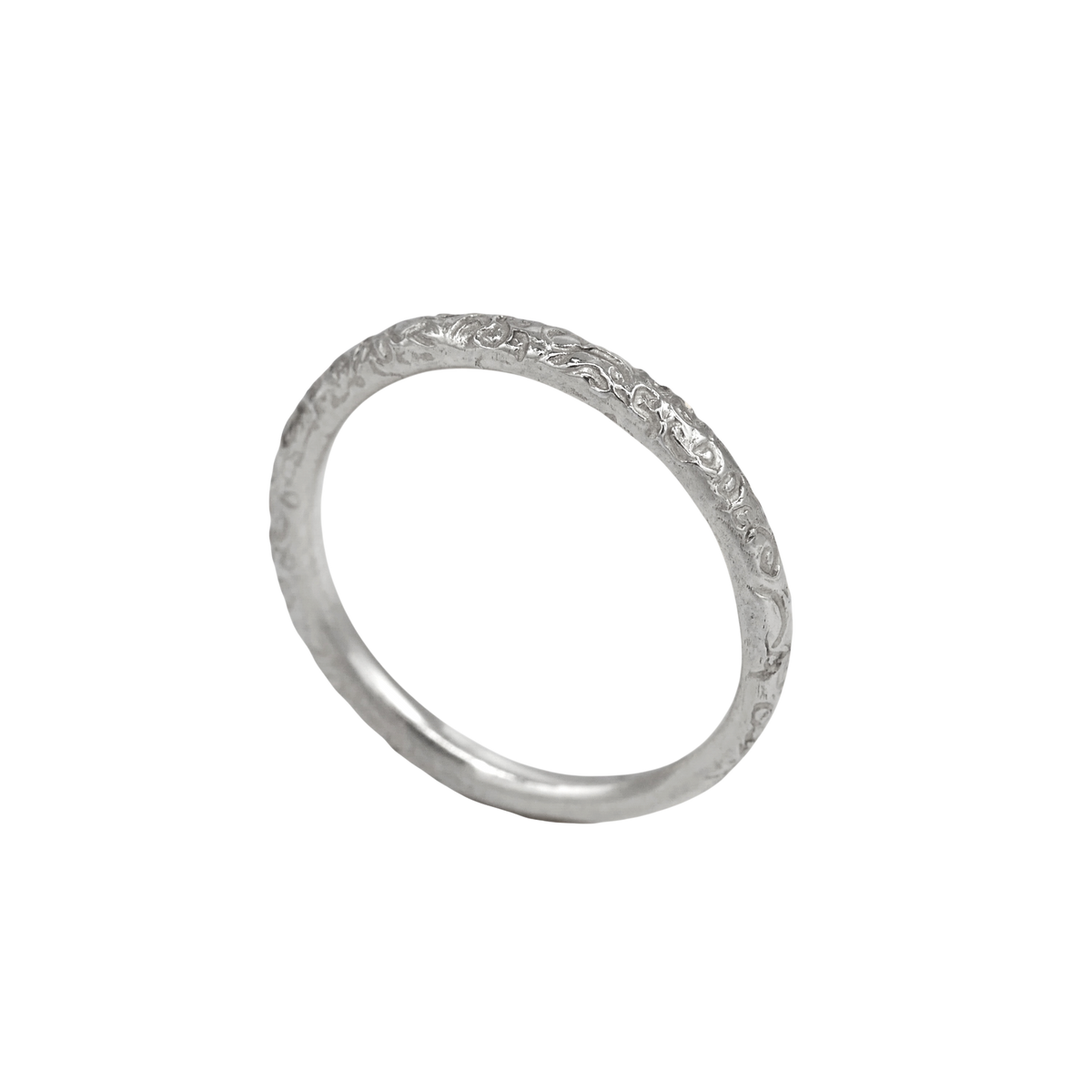 Little Scrolling Band Silver — angled view showing the textured outer surface and smooth inner band.