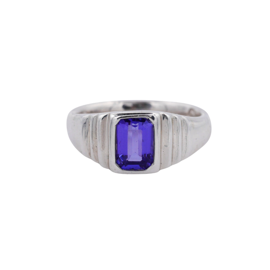 Meeting Place Ring Silver — A violet-blue rectangular tanzanite is bezel-set in a polished, ridged sterling-silver signet ring.
