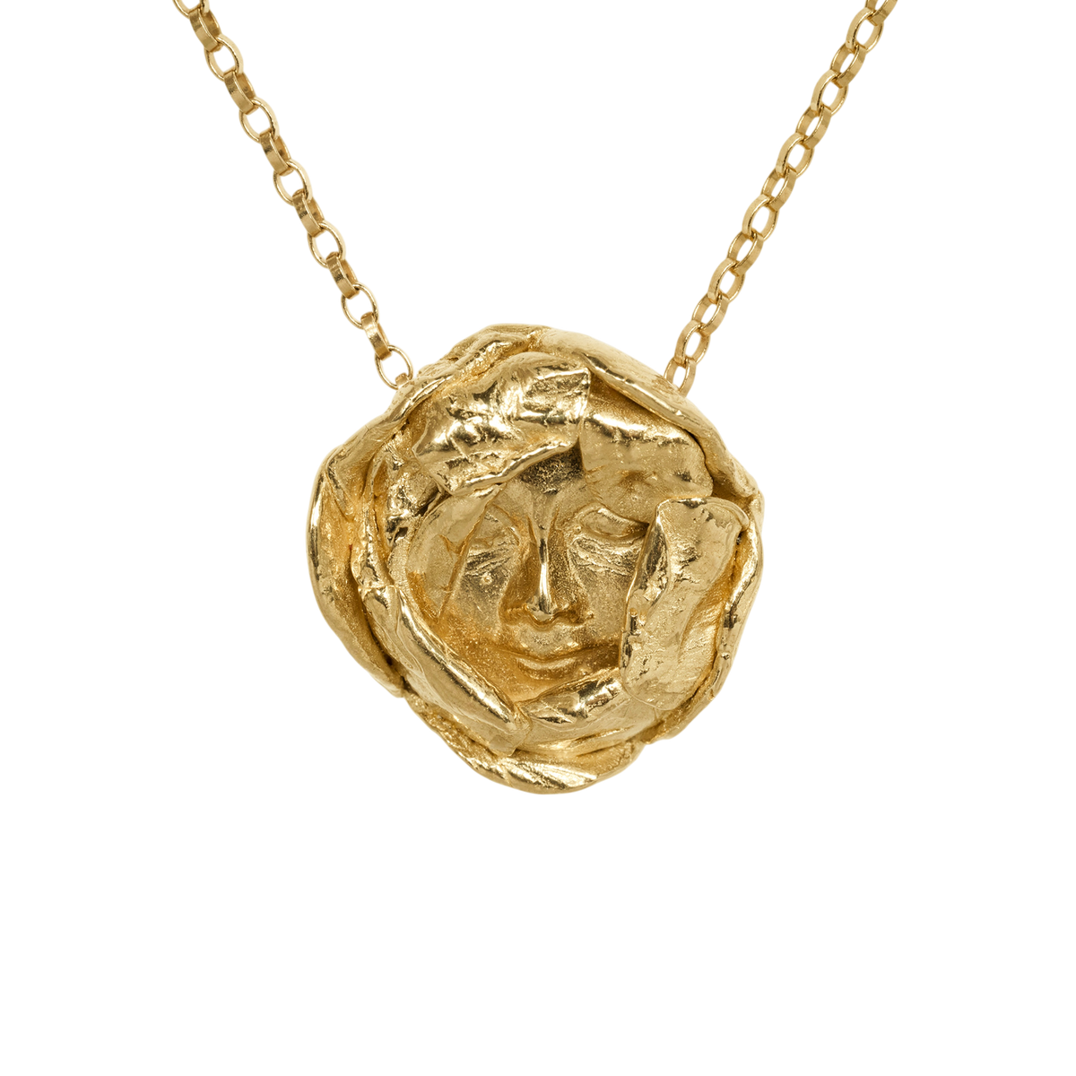 Messenger Pendant Necklace — An irregular yellow-toned medallion with a sculpted human face is suspended from a fine oval-link chain.