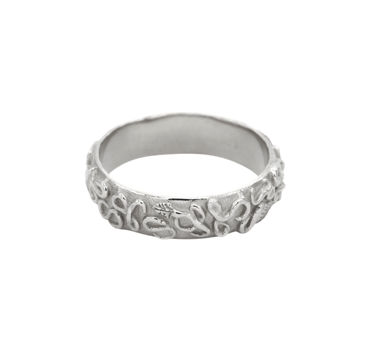 Revelation Band Silver — A broad sterling-silver band is wrapped in raised looping vines, leaves, and scrolling relief over a textured ground.
