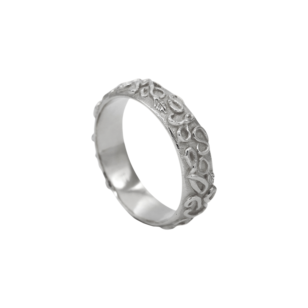 Revelation Band Silver — angled view showing the scrolling relief around the silver band.