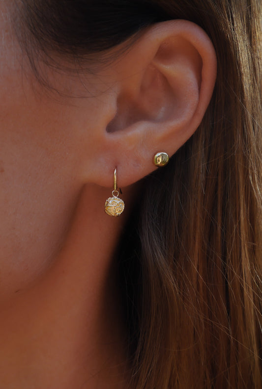 Revelation Single Drop Earrings — one drop earring worn on an ear.