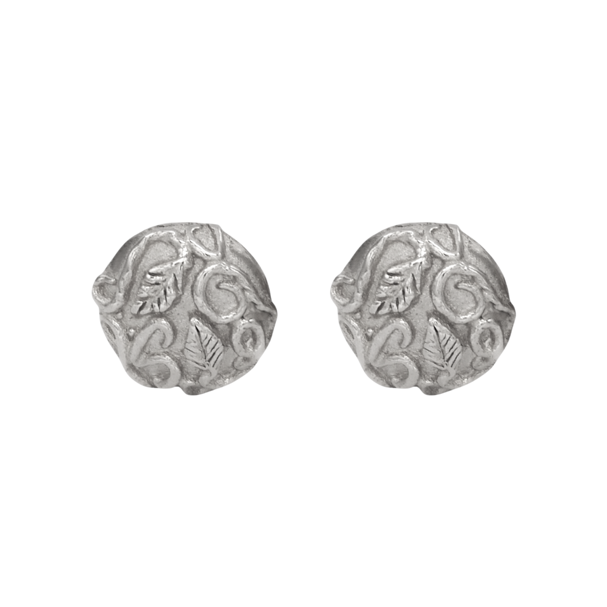 Revelation Stud Earrings Silver — Round sterling-silver studs display raised leaves and scrolling vines across softly irregular textured faces.