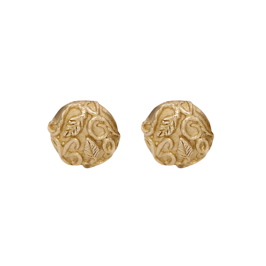 Revelation Stud Earrings — Round yellow-gold studs display raised leaves and scrolling vines across softly irregular textured faces.