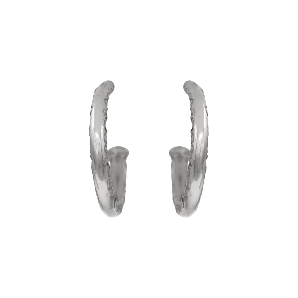 Scribe Hoops Silver — A pair of sterling-silver open hoops has rounded profiles and a repeating incised scroll motif across the outer face.