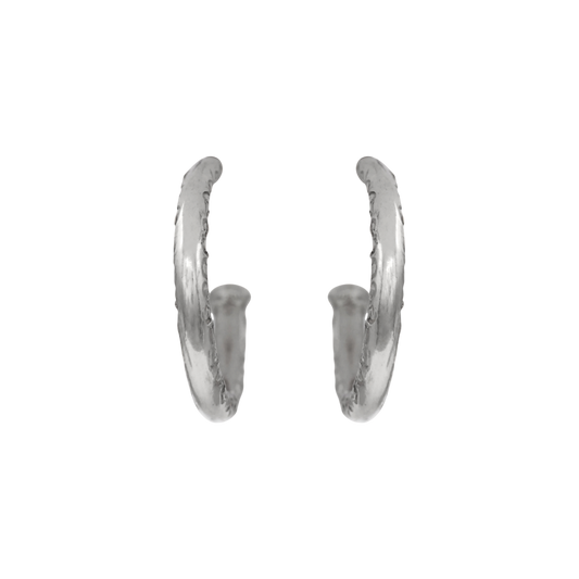 Scribe Hoops Silver — A pair of sterling-silver open hoops has rounded profiles and a repeating incised scroll motif across the outer face.