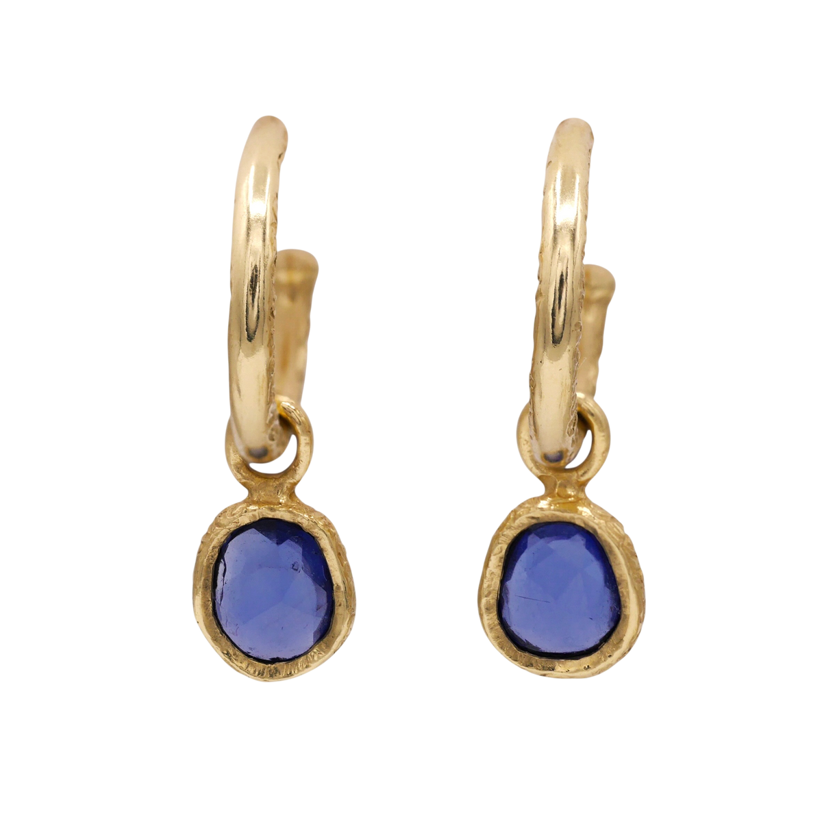 Sapphire Dewdrop Earrings — Two violet-blue irregular sapphires in textured yellow-gold bezels hang beneath smooth hoop tops.