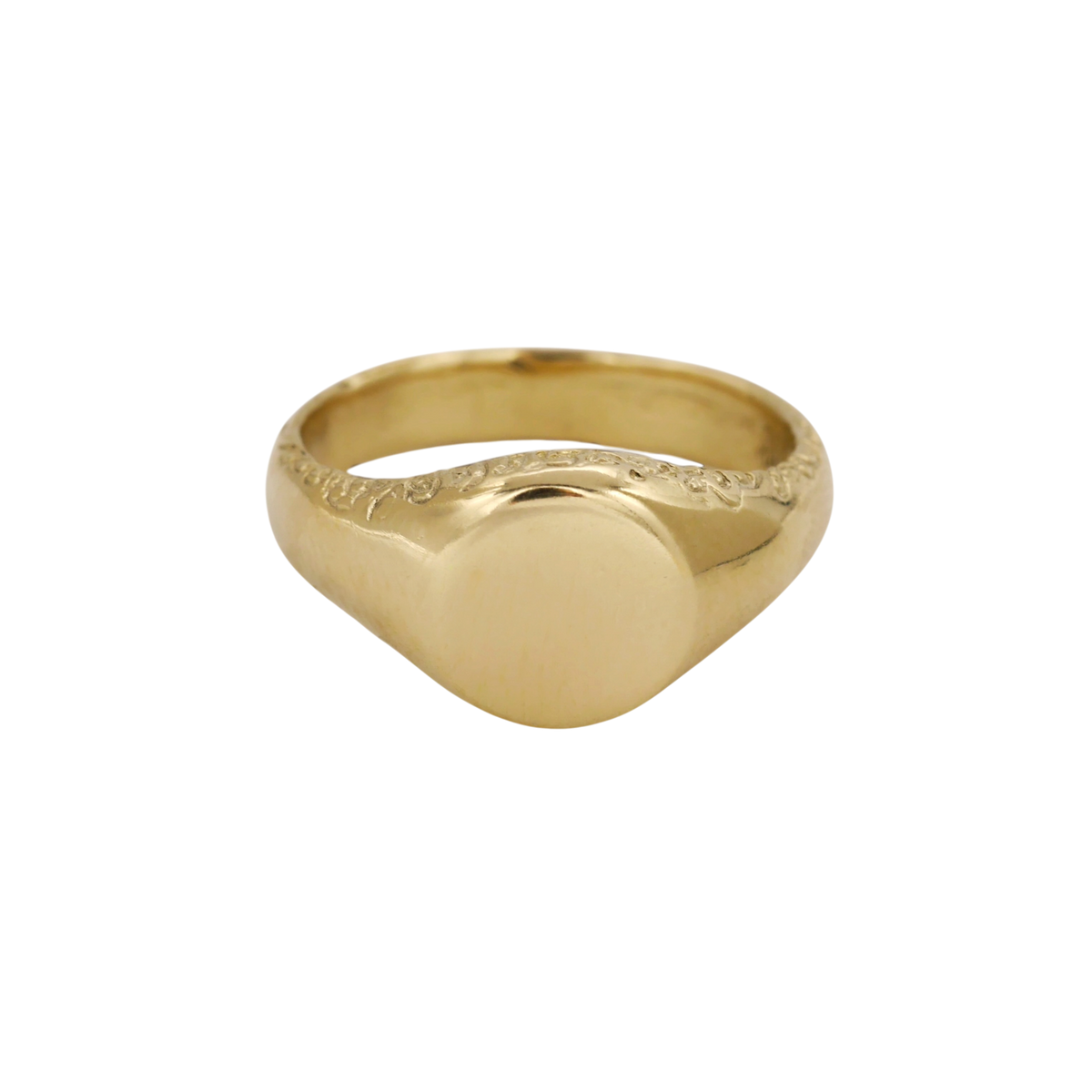 Scribe Signet Ring — A yellow-gold signet ring has a blank rounded face, broad tapered shoulders, and incised scrolling along the upper shank.