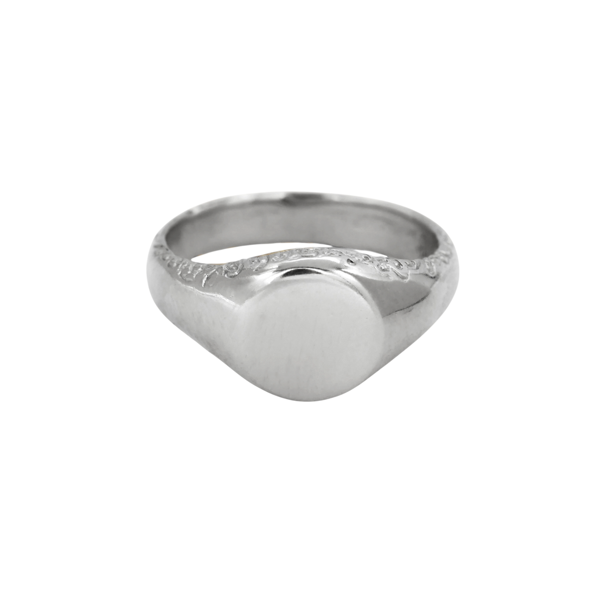Scribe Signet Ring Silver — A sterling-silver signet ring has a blank rounded face, broad tapered shoulders, and incised scrolling along the upper shank.