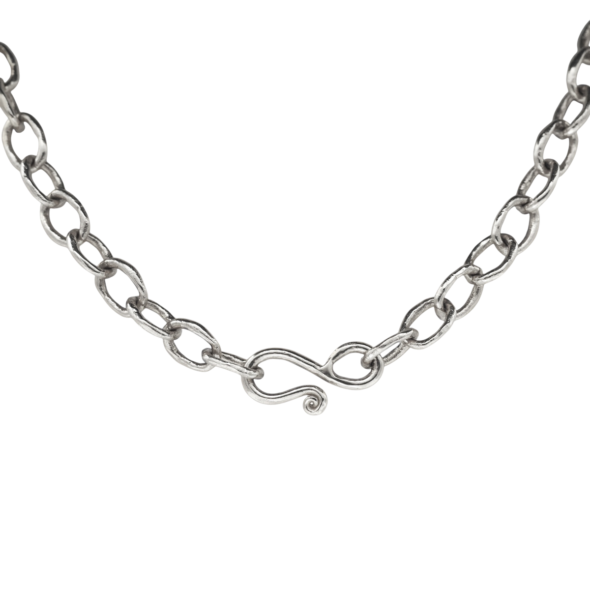 Silver Chain — A sterling-silver necklace is formed from irregular oval links and closes with a sculptural S-hook ending in a small spiral.