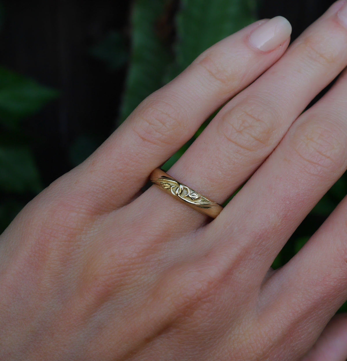 Tethered Ring — worn alone on a hand outdoors.