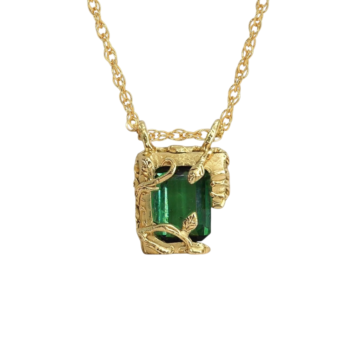 Tourmaline Chamber Pendant — A deep-green rectangular step-cut tourmaline is held in a yellow-gold-colored pendant frame formed from leaves, vines, and irregular sculptural prongs.