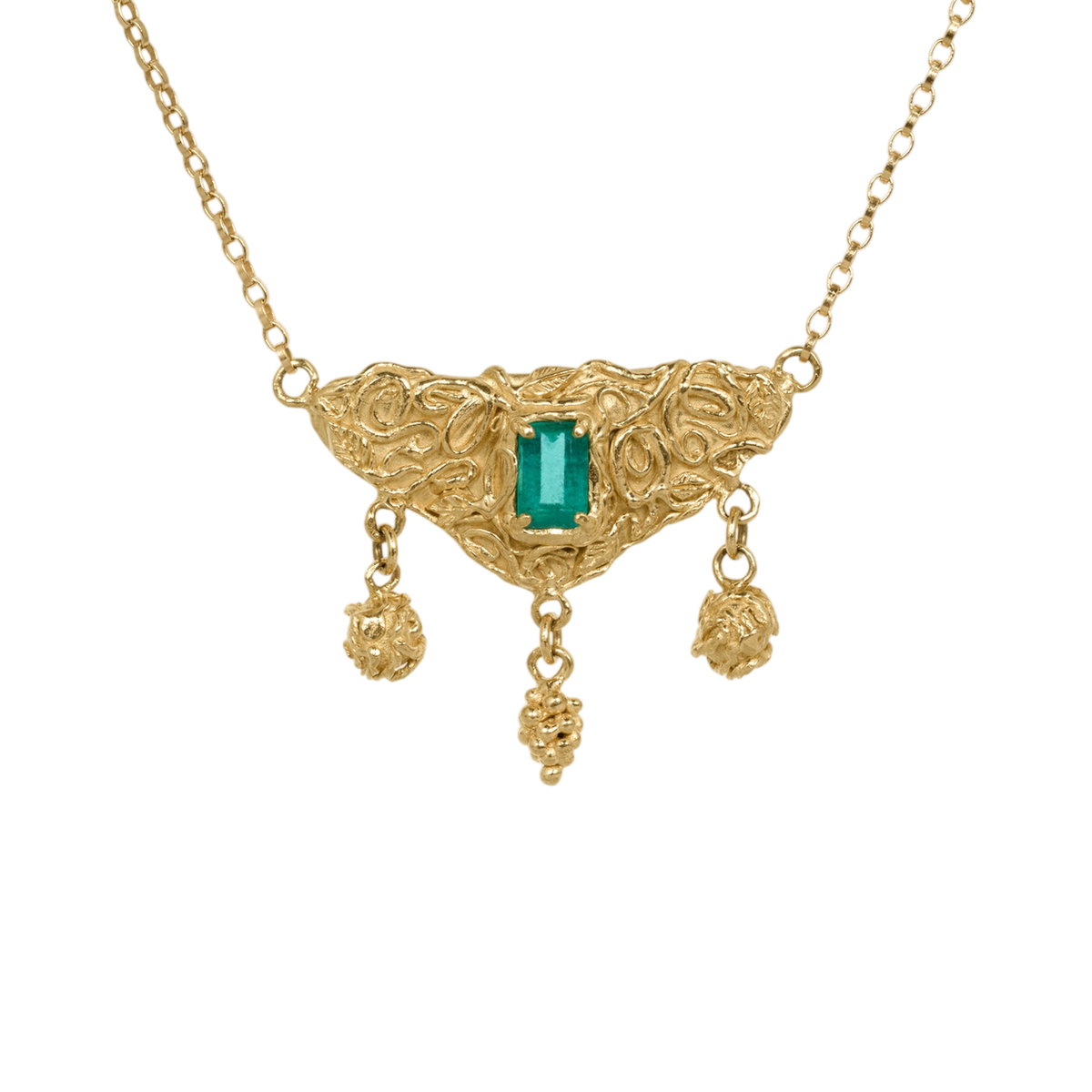 Utopia Necklace — An emerald-cut green emerald is prong-set in a triangular yellow-gold-colored centerpiece with open scrolling and three dangling sculptural drops.