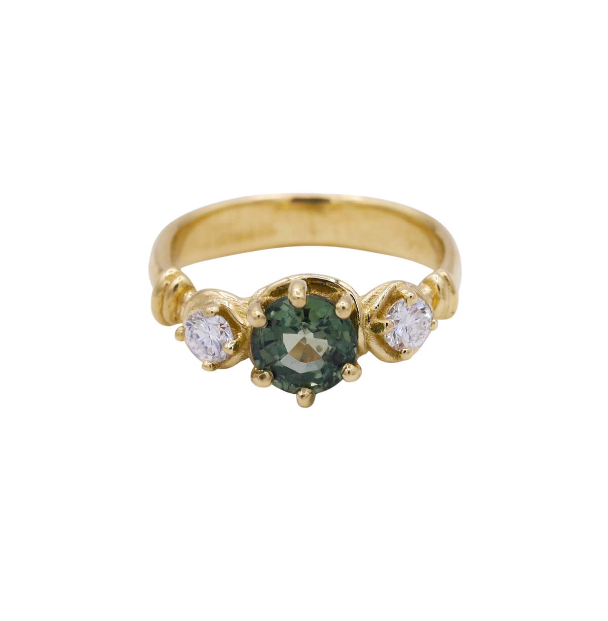 Verdant Ring — A round green sapphire is prong-set between two round colorless diamonds on a yellow-gold band with curled shoulder details.