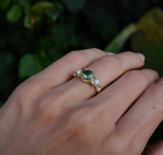 Verdant Ring — worn alone on a hand outdoors.