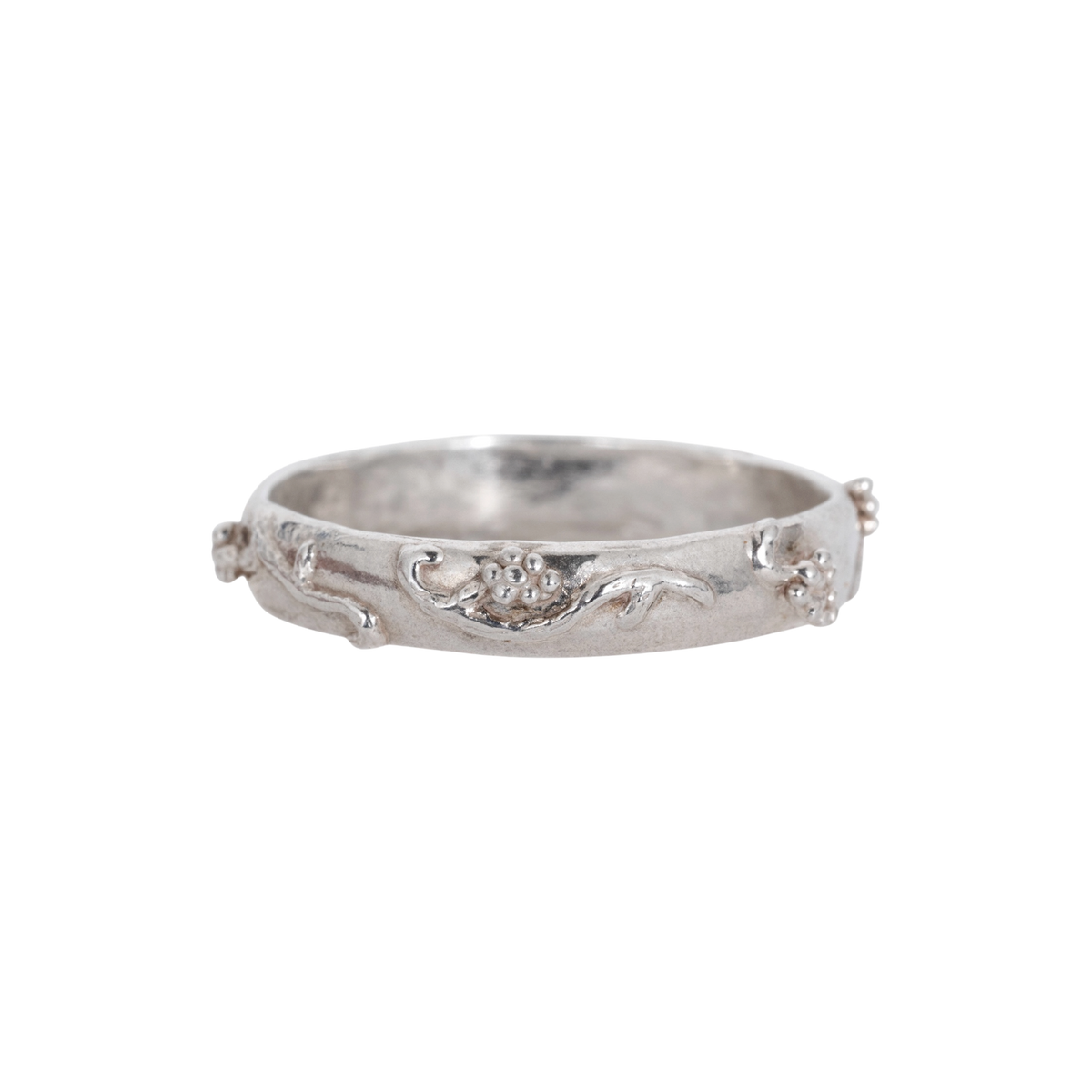Vineyard Ring Silver — A silver-colored band carries raised vine, leaf, and clustered-grape motifs over a softly textured surface.