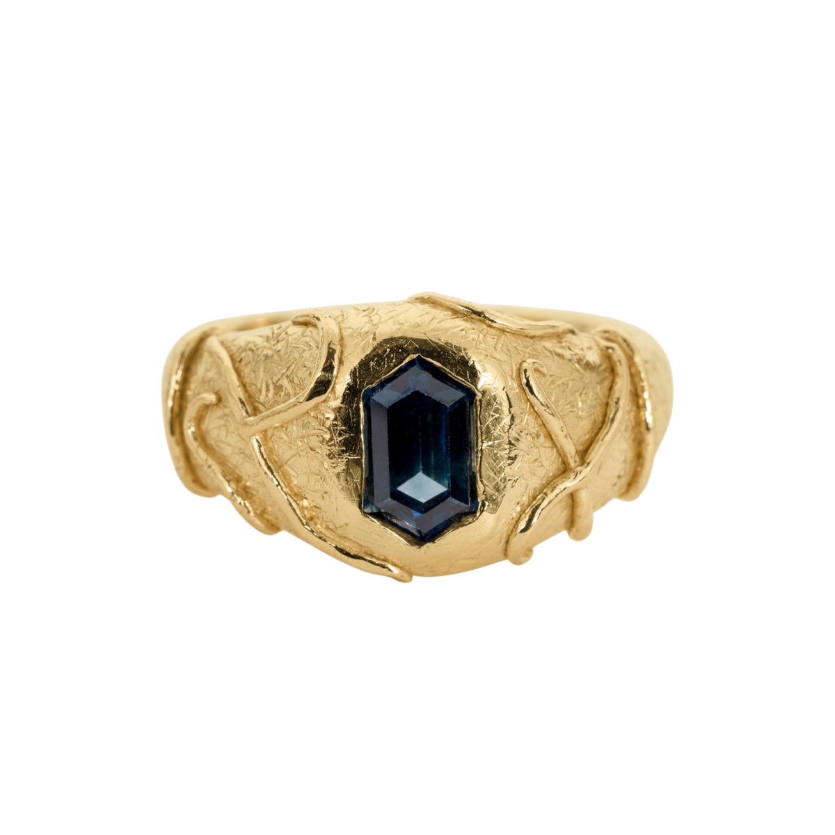 Blue Sapphire Signet Ring — A yellow-gold-colored signet ring centers a deep-blue elongated hexagonal sapphire in a sculptural bezel.