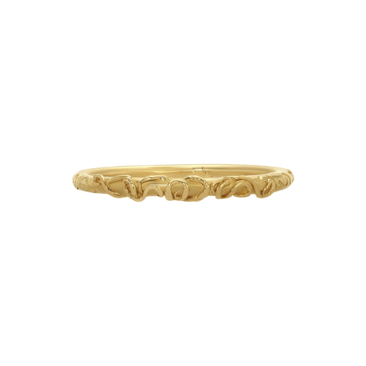 Zero Ring — A slim yellow-gold-colored band is wrapped with a continuous sequence of raised loops and compact spiral motifs.